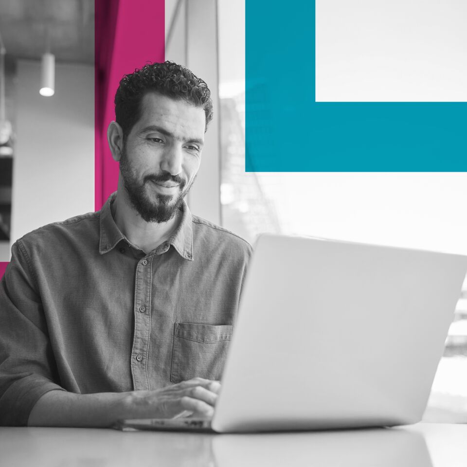 SINGLE-IMAGE_squares-smiling-young-businessman-working-on-a-laptop_may25