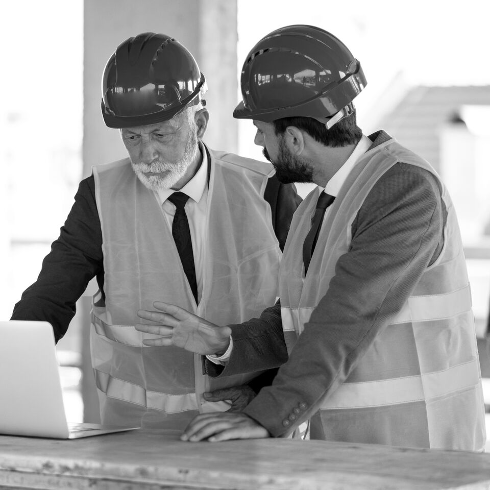 SINGLE-IMAGE_workers-at-construction-site-looking-at-laptop_jan25