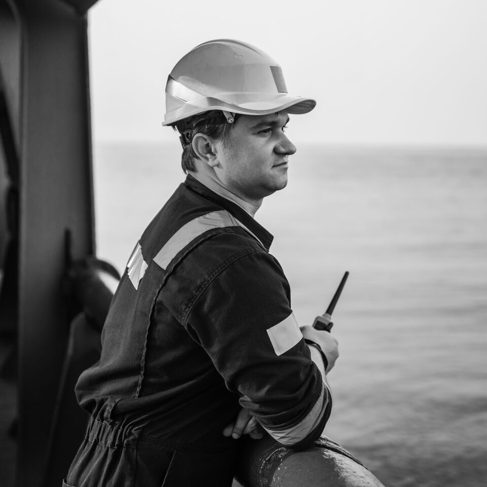 SINGLE-IMAGE_male-engineer-on-deck-holding-walkie-talkie_jul24